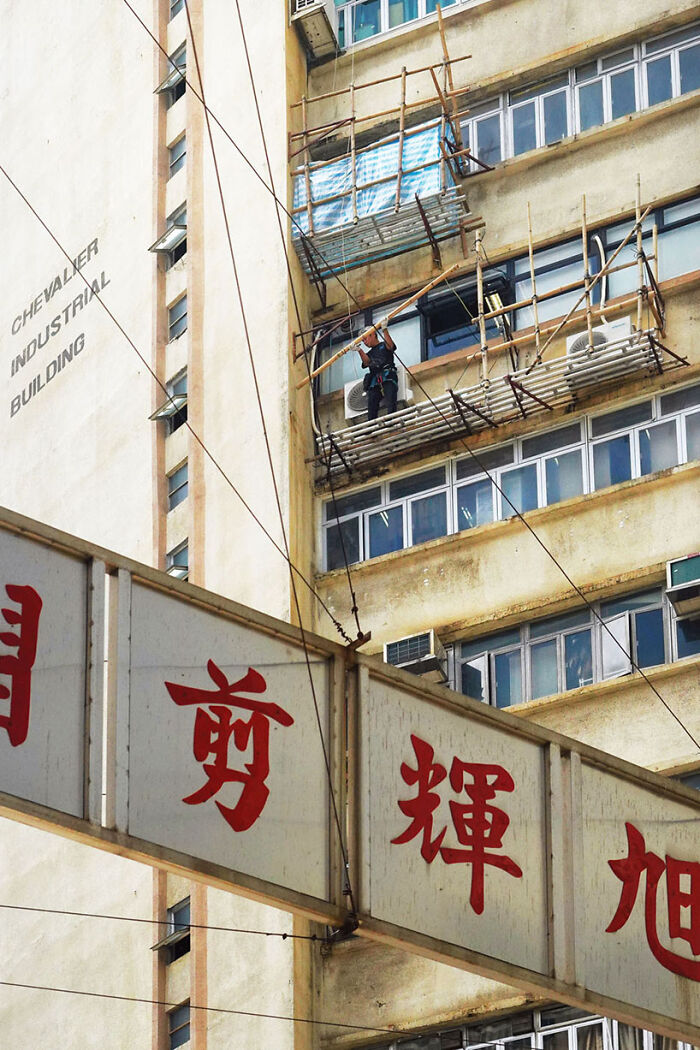 Repair Chevalier, 2024 - A Worker Holding A Bamboo Pole For The Scaffolding He Is Constructing