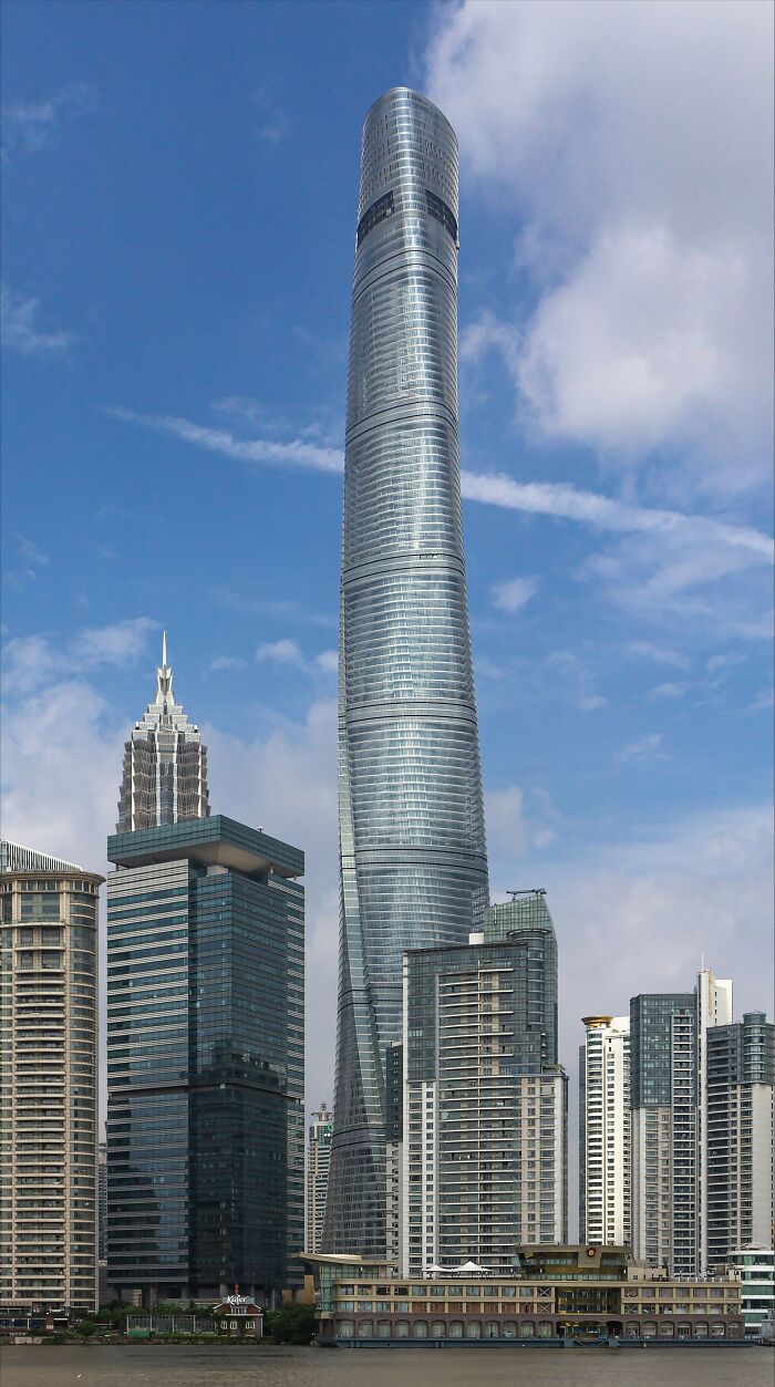 Tall skyscraper in city skyline, representing worlds' tallest buildings, with a clear blue sky backdrop.