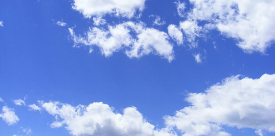 Clear blue sky with fluffy clouds, illustrating ethical dilemmas and choices to consider.