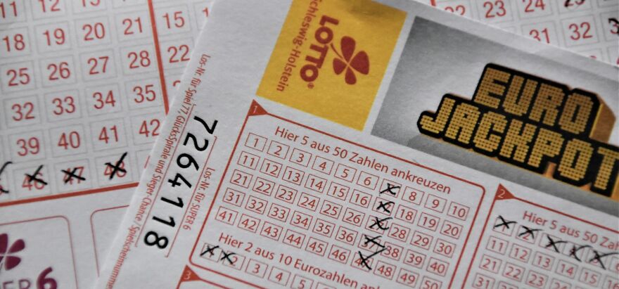 Lotto tickets with marked numbers, posing an ethical dilemma.
