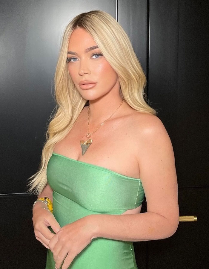 Blonde woman in a green dress, related to ongoing cancer battle.