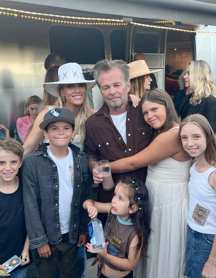 Group of people, including Teddi Mellencamp's dad, smiling together outdoors amidst cancer battle news.