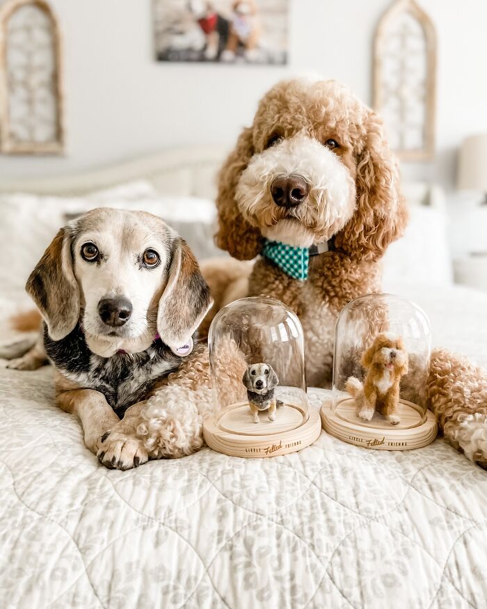 Cute felted pet versions next to an adorable beagle and poodle on a cozy bed.