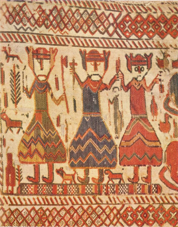 Ancient artwork depicting a triple threat deities group with three stylized gods wearing patterned robes and crowns.