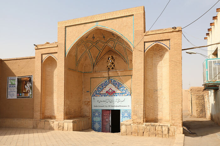 Entrance to an underground city showcasing traditional brick architecture and decorative tilework.