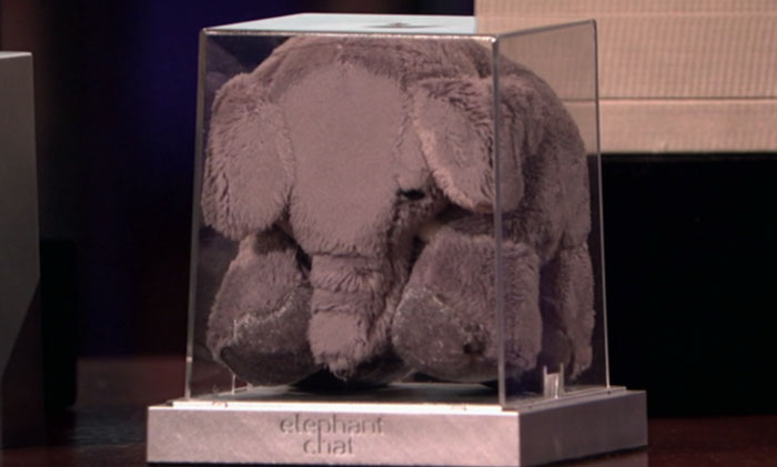 Plush elephant toy displayed in a clear case representing one of the Shark Tank products that completely flopped.