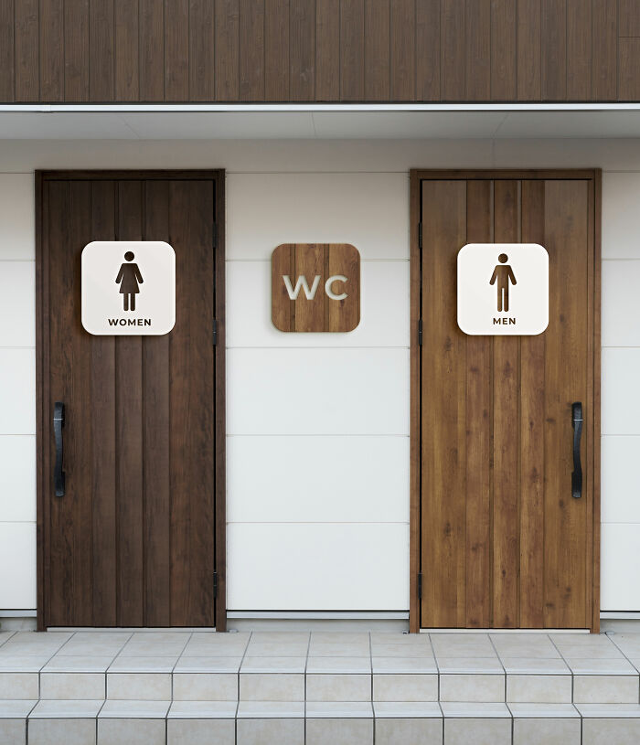 European WC signage with separate wooden doors marked for men and women.