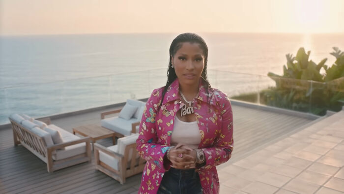 Person standing on a luxury outdoor deck with ocean view, representing celebrity homes that were broken into.