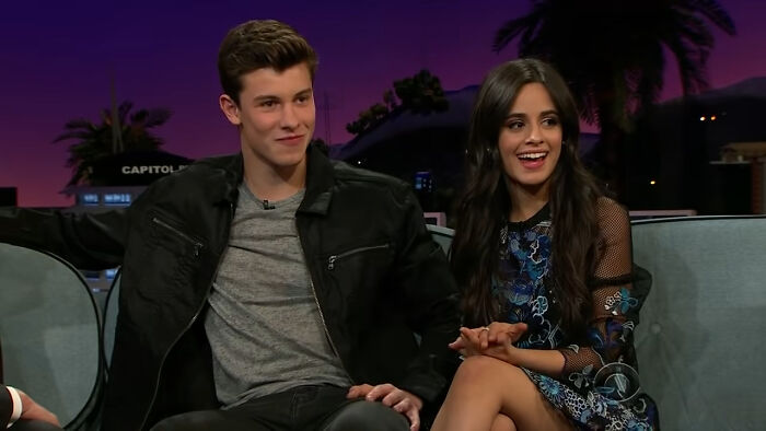 Two celebrities sitting on a talk show couch, discussing incidents involving celebrity homes broken into.