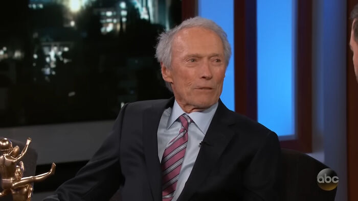 Elderly man in a suit and striped tie during a TV interview as part of celebrity encounters that went really well or bad.