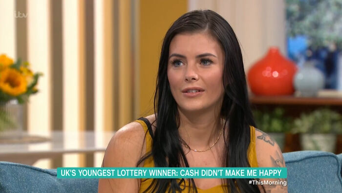 Young woman sharing her story as a lottery winner discussing unfortunate experiences despite winning a large amount of money.