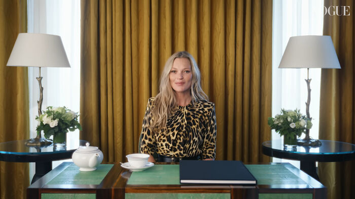 Blonde woman sitting at table in a leopard print top with lamps and flowers, related to celebrity homes broken into.