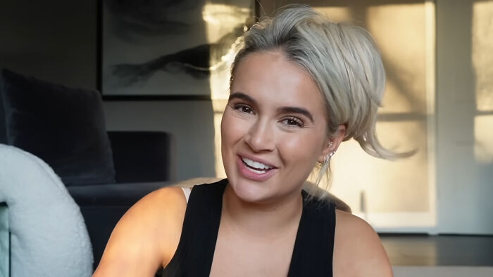 Young woman with blonde hair smiling indoors, illustrating celebrity homes broken into and related security concerns.