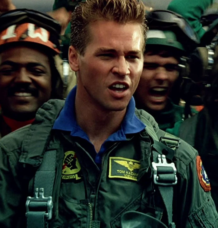 Actor in military gear portraying a pilot, capturing a tense scene.