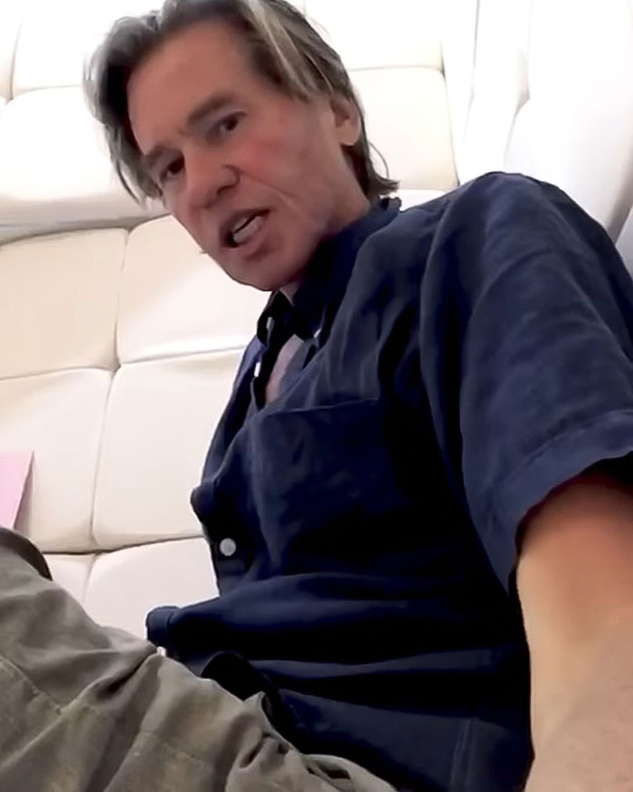 Man wearing a blue shirt seated on a white couch, associated with the Batman star's last social media post.