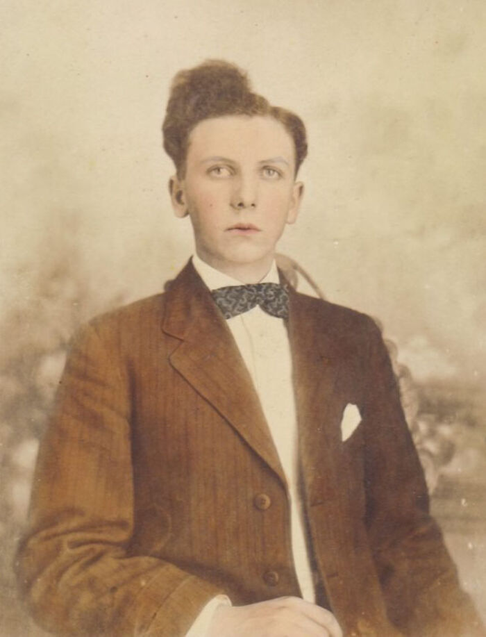Vintage hairstyle from yesteryear, featuring a young man in a suit and bow tie with a unique hairdo.