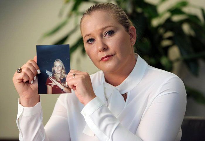 Woman in white shirt holding a photo, related to Prince Andrew accuser's final posts.