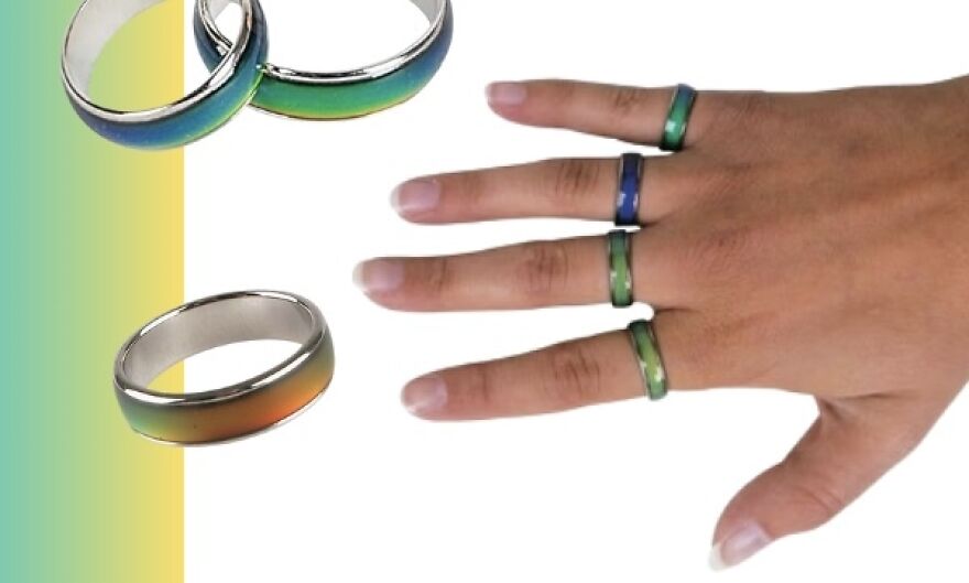 Hand wearing mood rings, showcasing viral trends in colorful jewelry.