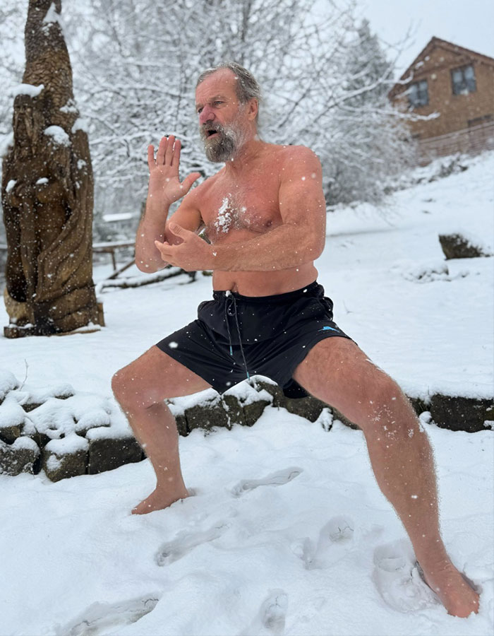 Man demonstrating real-life superpower by standing in snowy landscape shirtless, showcasing cold resistance capability.