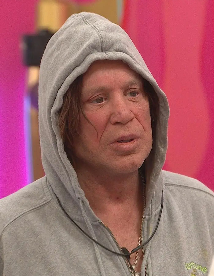Actor in a gray hoodie during a moment from 'Celebrity Big Brother,' related to controversial comments.