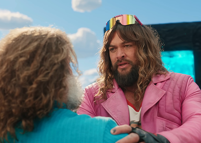 Two men in colorful outfits talking intensely, related to a TikTok trend at a 'Minecraft Movie' event screening. Two men in colorful outfits talking intensely, related to a TikTok trend at a 'Minecraft Movie' event screening.