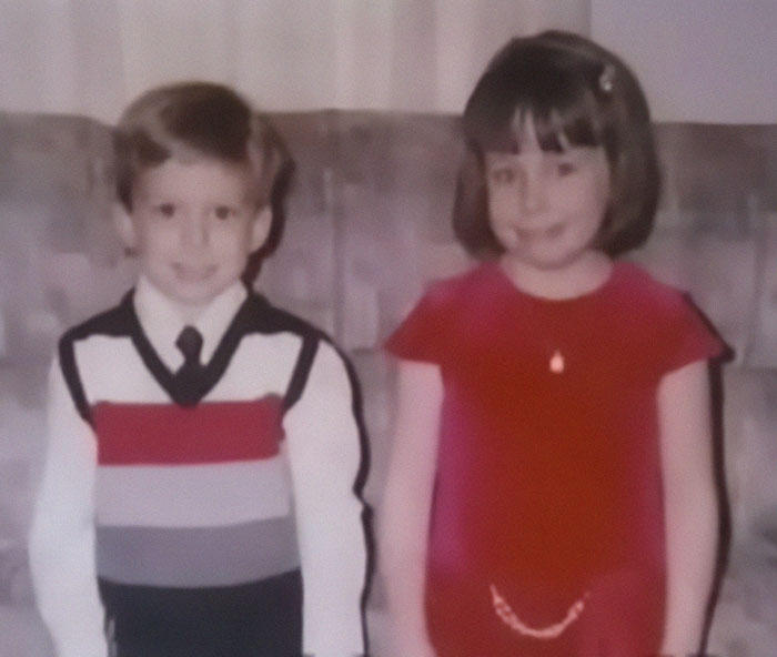 Two children dressed nicely, sitting on a couch, relevant to a story involving a life sentence.