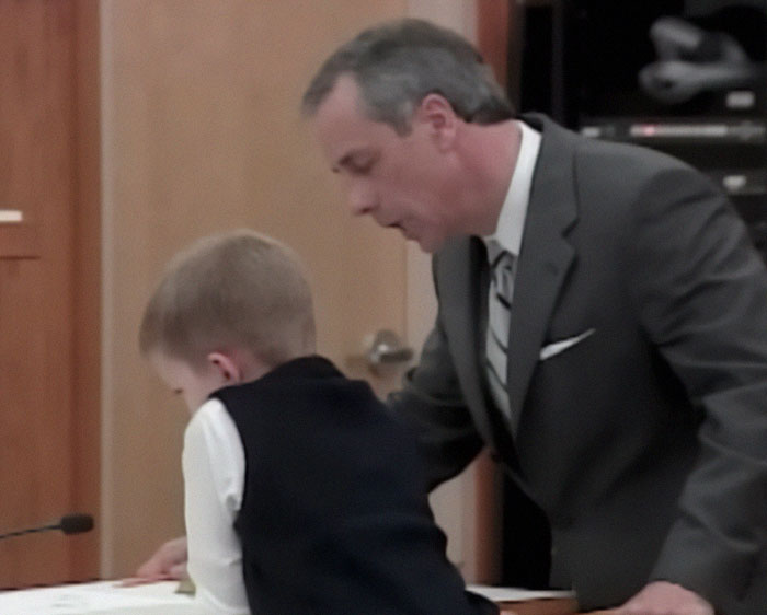 Child in court with lawyer, related to son's silence after mom's life sentence.