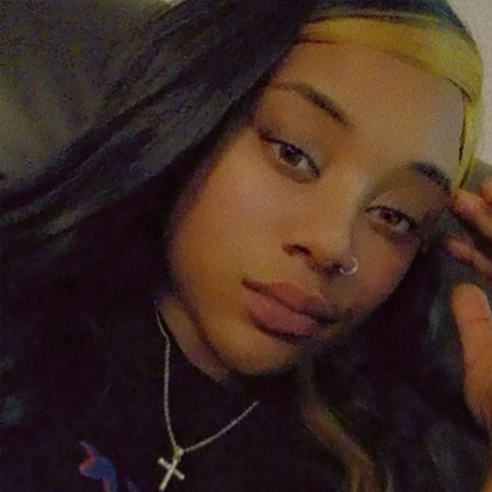 Black woman with long hair and a cross necklace, related to viral video incident.