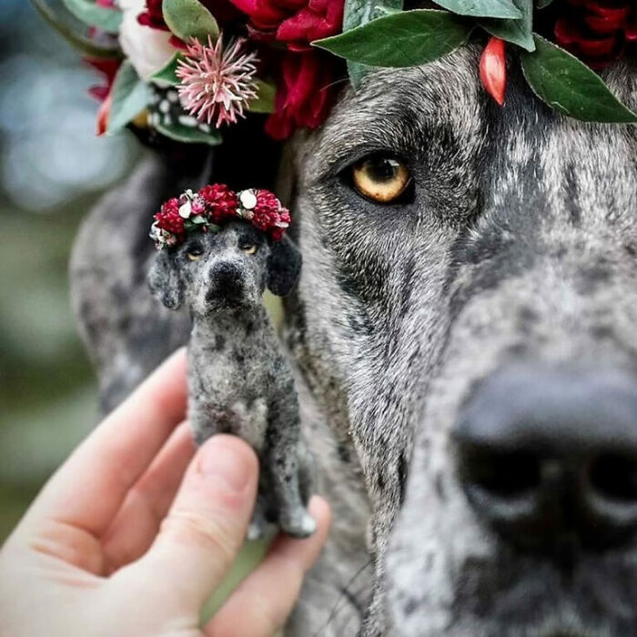 Cute felted pet replica next to a dog, both wearing flower crowns.