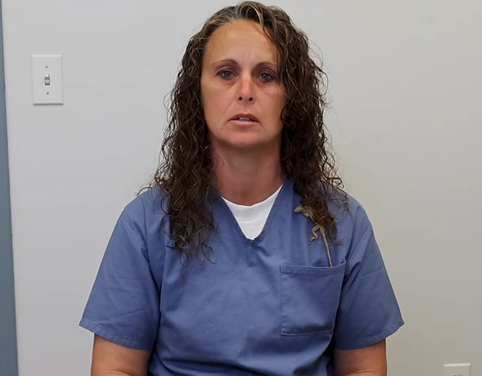 Woman in blue prison uniform, facing camera; related to life sentence story.
