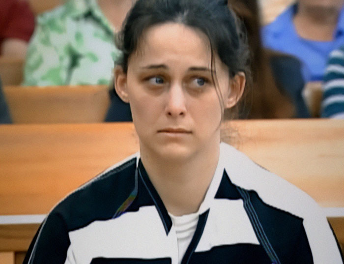 Woman in court looks emotional, related to son sending mom to prison for life sentence.