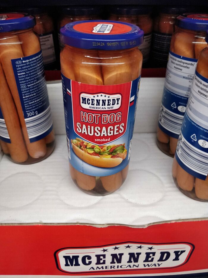 Jar of McEnnedy American Way hot dog sausages on a store shelf, showcasing American food available internationally.