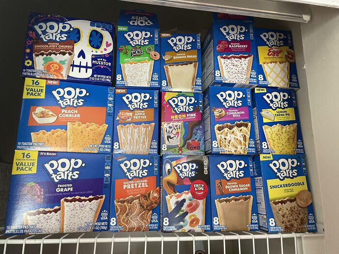 Various Pop-Tarts flavors in a store shelf, showcasing diverse American food options available internationally.