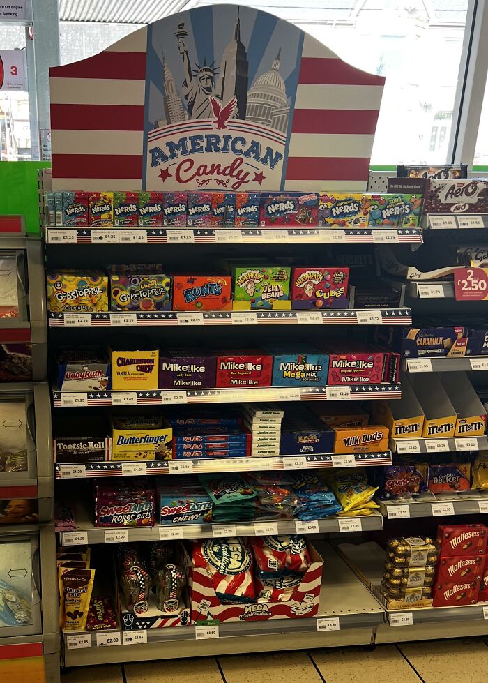 American candy shelf in a store featuring Nerds, Mike and Ike, and Butterfinger.
