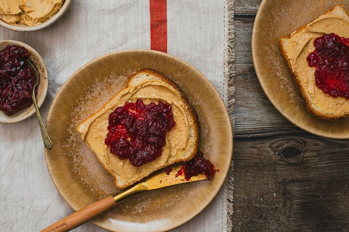 Peanut butter and jelly sandwich on a plate, showcasing an American classic dish.