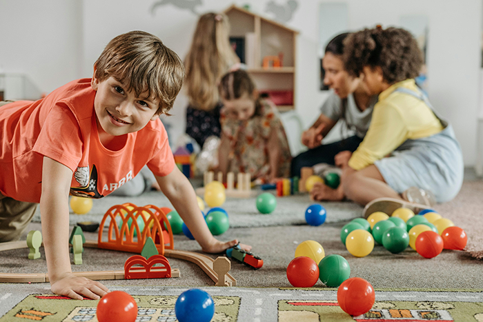 Children playing with colorful toys indoors, engaging in creative activities together.