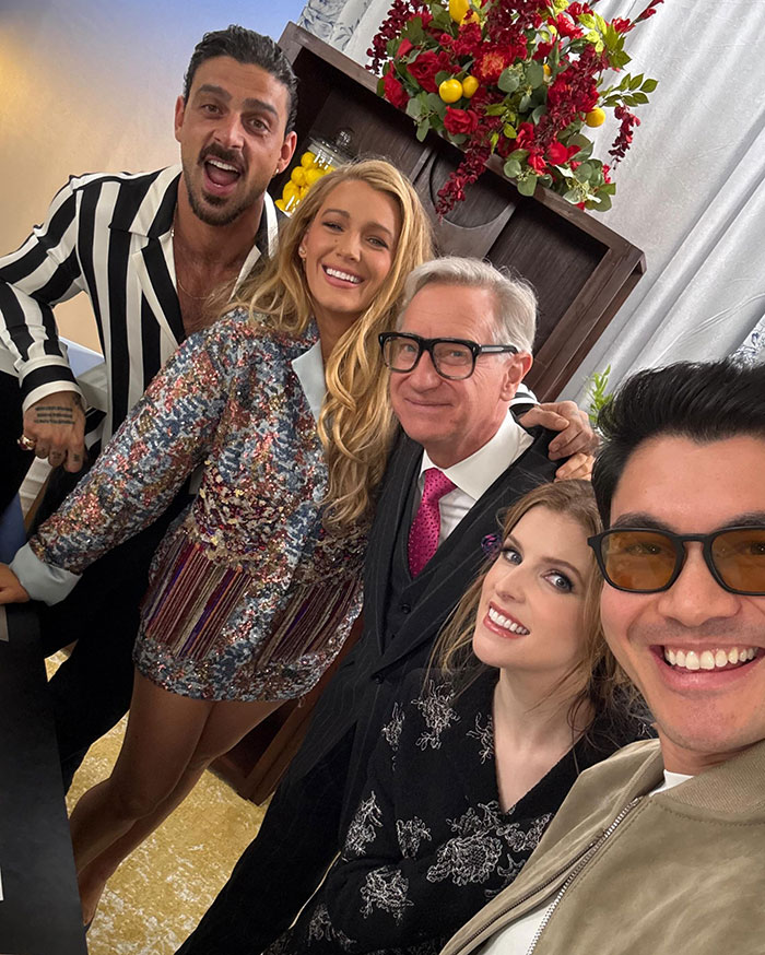 Group posing for a selfie at a glamorous event, featuring a wardrobe malfunction involving a spray tan rubbed off.