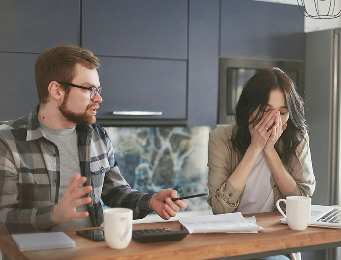 Man makes April Fools’ joke, causing upset girlfriend to react, in a tense kitchen setting. Man makes April Fools’ joke, causing upset girlfriend to react, in a tense kitchen setting.