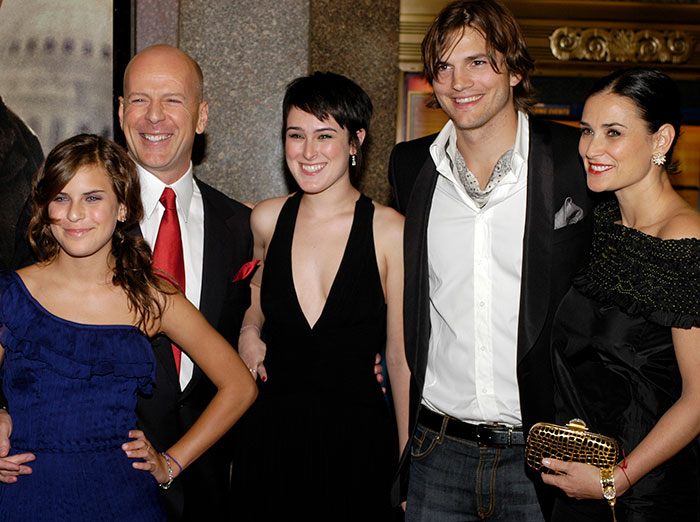 Group photo including Demi Moore's daughter and Ashton Kutcher at a formal event.