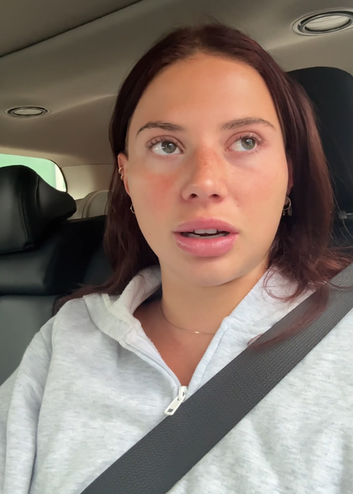 Influencer in a car discussing a scary incident during Coachella, wearing a gray hoodie and seatbelt fastened. Influencer in a car discussing a scary incident during Coachella, wearing a gray hoodie and seatbelt fastened.