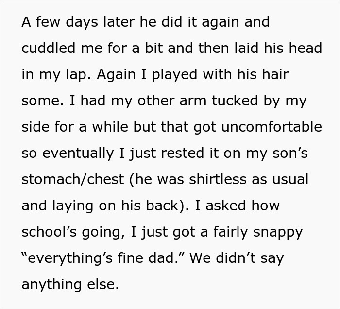 Teen boy snuggles with dad, resting head in his lap while dad plays with his hair; a comforting family moment.