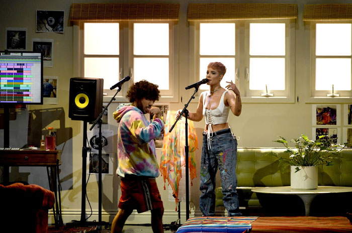 Benny Blanco in a colorful hoodie, performing in a studio, showcasing his hitmaker talents.