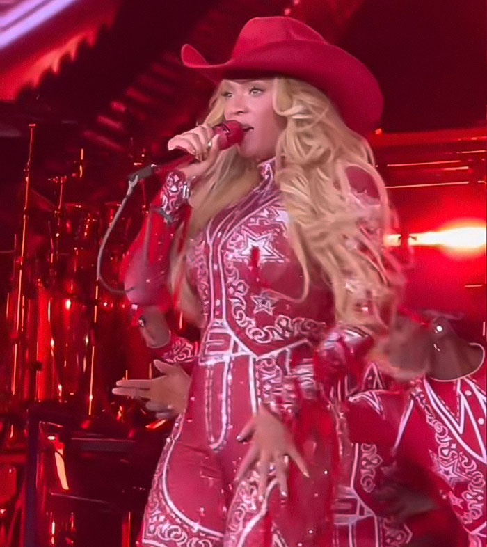 Beyonc&eacute; performing live in a red outfit with cowboy hat, amid controversy involving Jay-Z and daughter Blue Ivy&rsquo;s live performance.