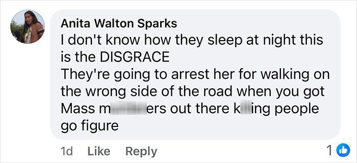 Comment discussing detaining a Black woman for walking on the wrong side of the road, highlighting perceived injustice.