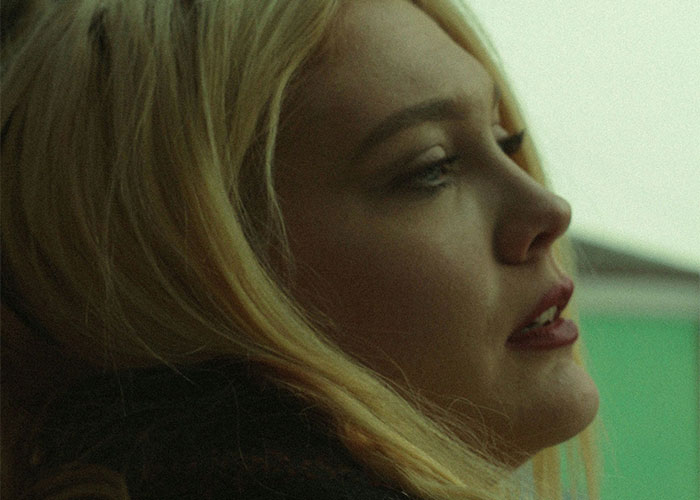 Woman looking thoughtful after being dumped, with soft lighting highlighting her profile.