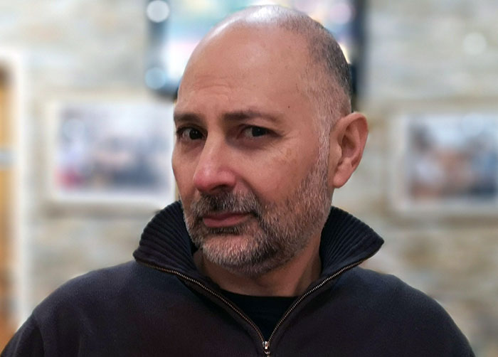 Man with a skeptical expression, emphasizing themes of traders&rsquo; arrogance and unexpected outcomes in a casual setting.