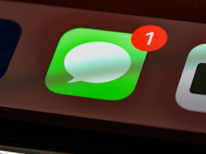 Close-up of a smartphone screen showing a new message notification, symbolizing relationship arguments through texting.