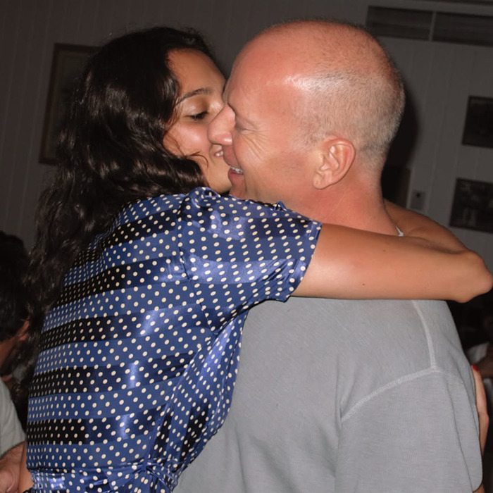 Man embracing woman, both smiling, conveying warmth and affection, related to Bruce Willis' wife's thoughts on his dementia. Man embracing woman, both smiling, conveying warmth and affection, related to Bruce Willis' wife's thoughts on his dementia.