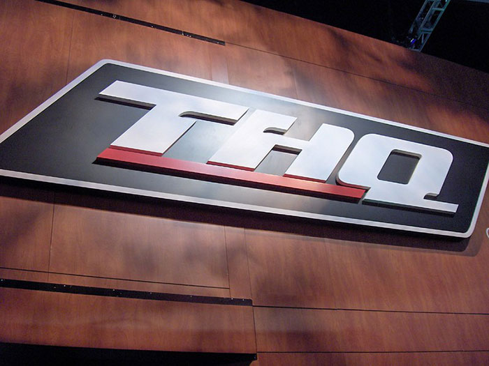 THQ company logo on wooden wall, representing a business affected by a bad decision.