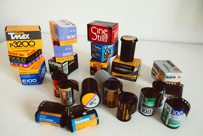 Various Kodak and film brands displayed on a white surface, illustrating companies affected by a single bad decision.